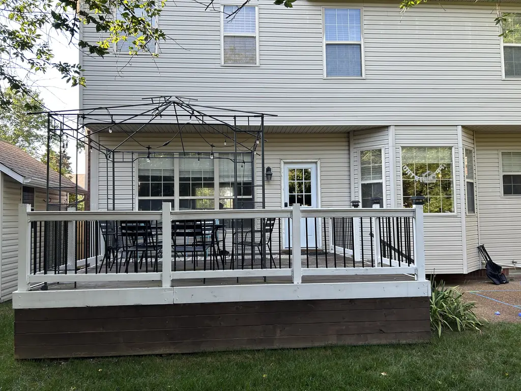 Finished deck with white railing and a pergola in Nashville, Tennessee