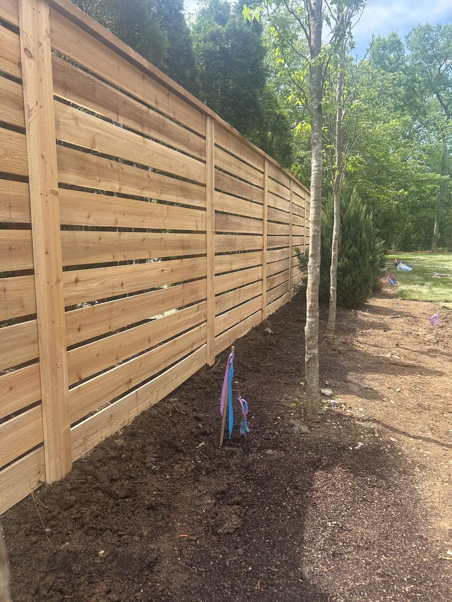Modern horizontal slat wood fence in a Nashville, Tennessee backyard