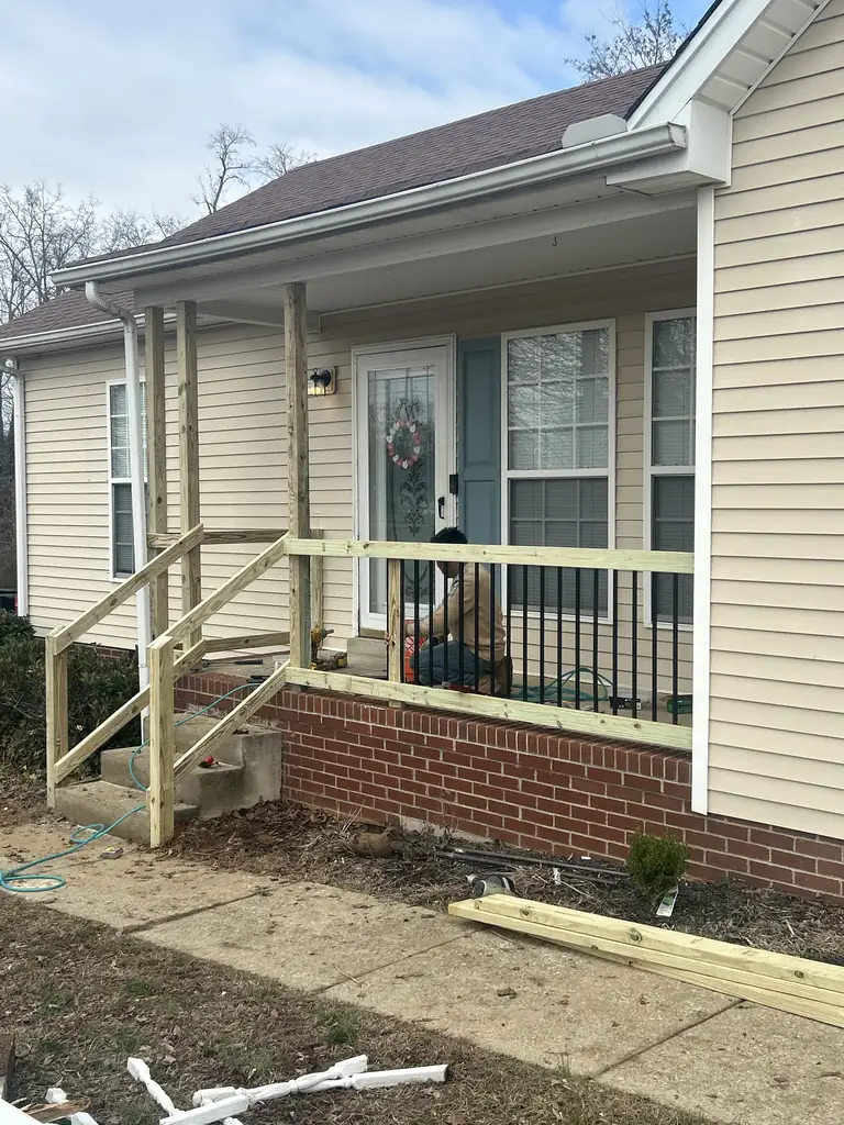 Covered front porch with wood railing built in Nashville, Tennessee