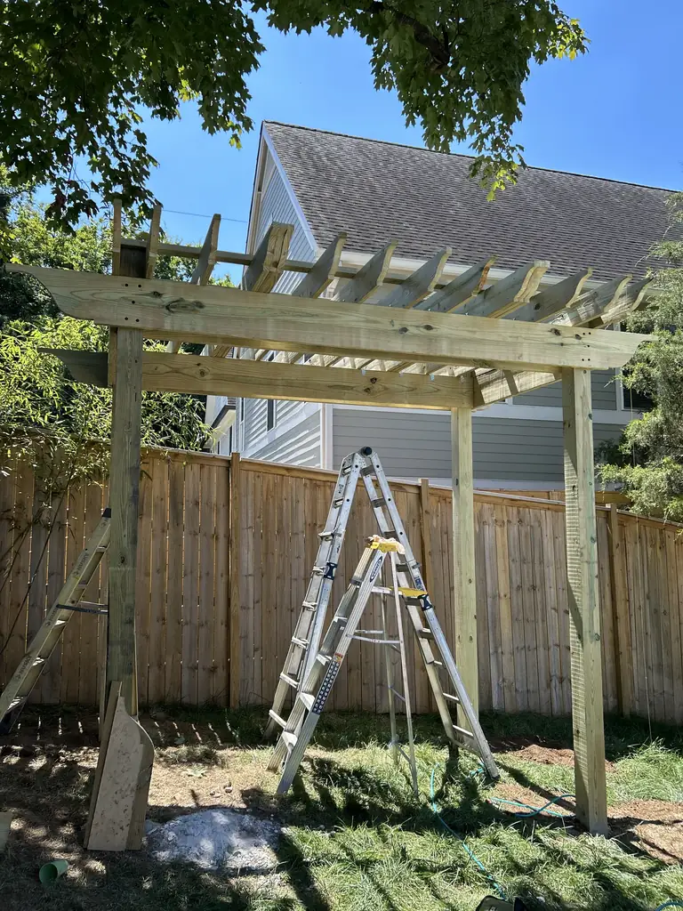 Wood pergola being framed over a backyard patio in Nashville, Tennessee